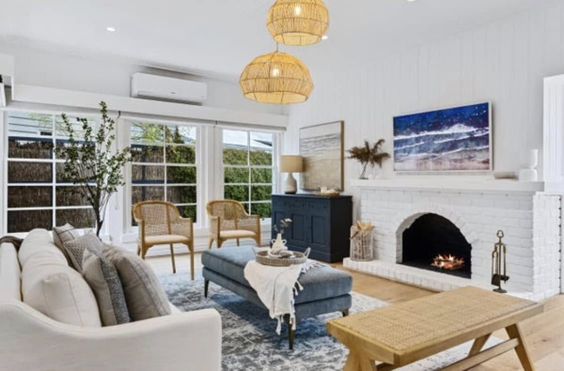 Freshly painted coastal living room in warm whites